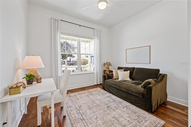 interior space featuring a ceiling fan, baseboards, and dark wood-type flooring