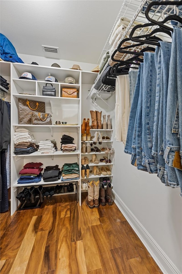 walk in closet featuring wood finished floors and visible vents