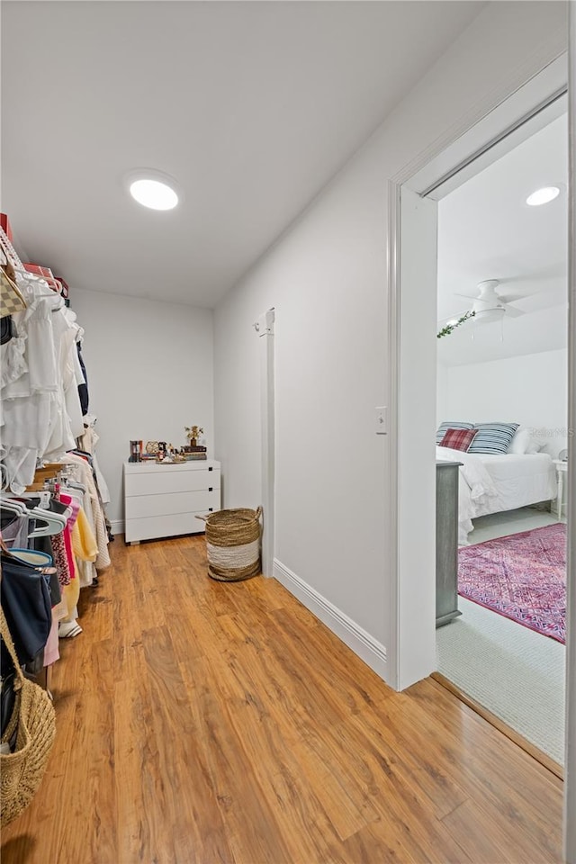 walk in closet featuring a ceiling fan and wood finished floors
