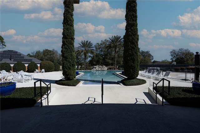 pool with fence and a patio area