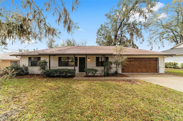 ranch-style home with brick siding, driveway, an attached garage, and a front lawn