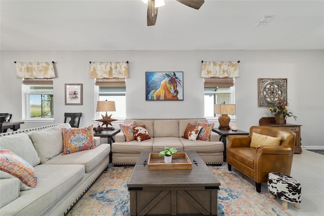 living room featuring visible vents and a ceiling fan