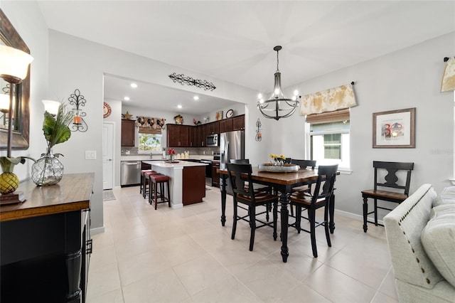 dining area featuring recessed lighting, baseboards, a notable chandelier, and light tile patterned floors