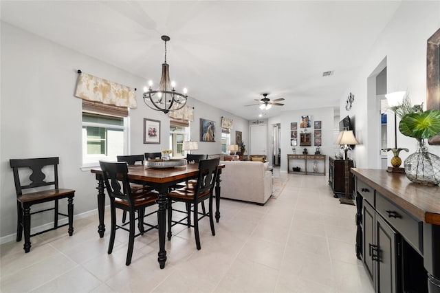 dining space featuring visible vents, baseboards, light tile patterned flooring, and ceiling fan with notable chandelier