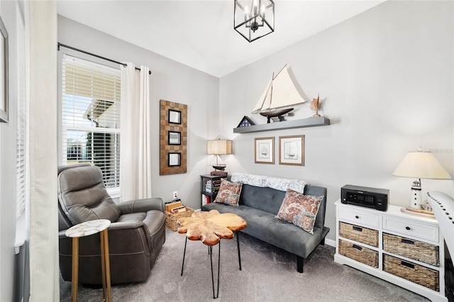 sitting room with carpet flooring and a chandelier