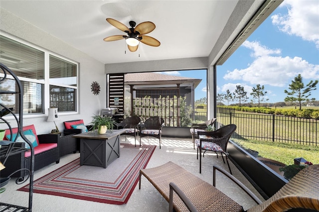 sunroom featuring ceiling fan