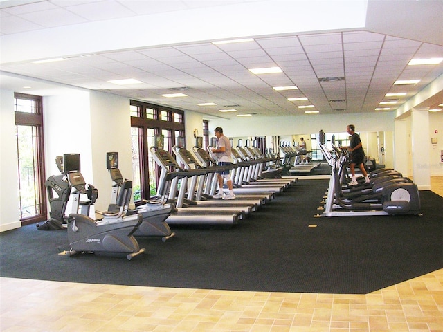 gym with a paneled ceiling