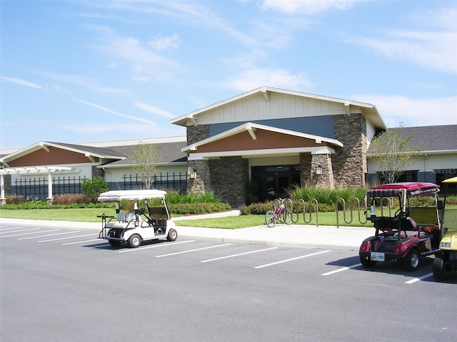 view of property featuring uncovered parking and fence