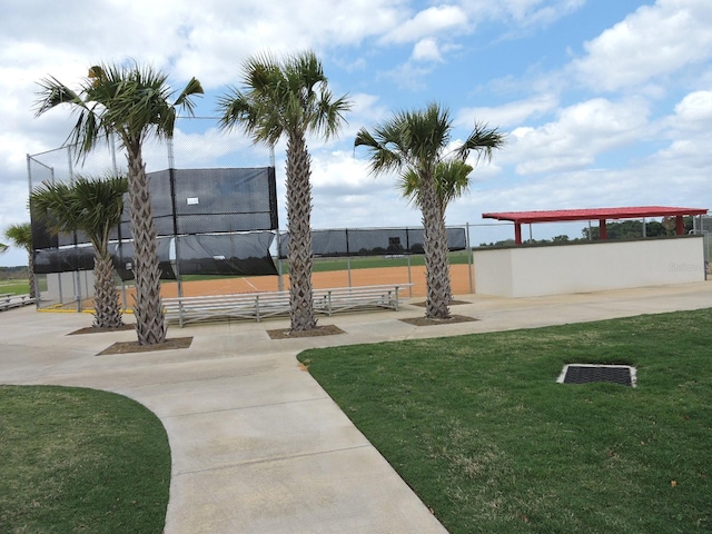 view of community featuring a yard and fence