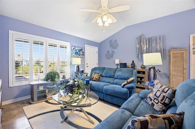 tiled living area featuring lofted ceiling, a ceiling fan, and baseboards