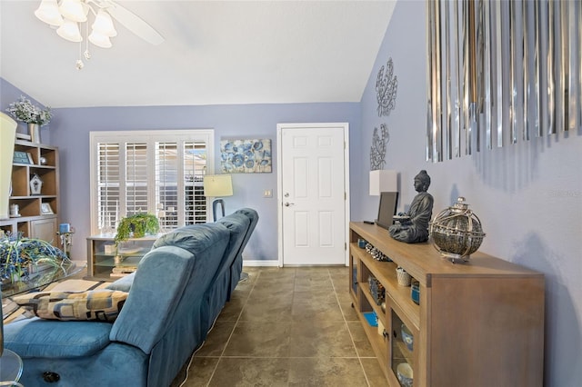 tiled living room with vaulted ceiling, a ceiling fan, and baseboards