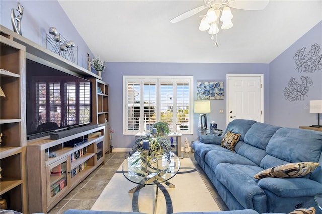 living room with vaulted ceiling, a ceiling fan, and baseboards