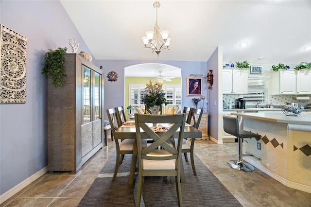 dining area with baseboards, arched walkways, and plenty of natural light