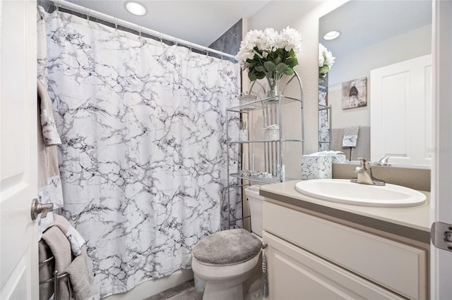 full bathroom with recessed lighting, toilet, and vanity