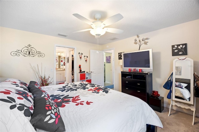 bedroom with ceiling fan, visible vents, carpet floors, and a textured ceiling