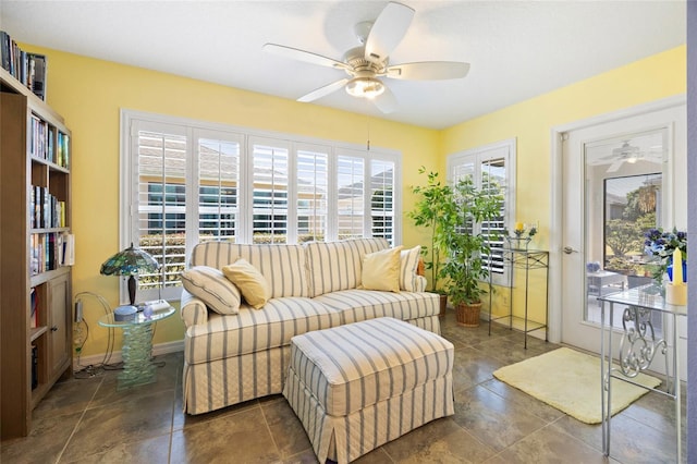 sitting room featuring baseboards and ceiling fan