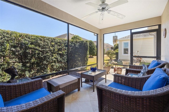 sunroom featuring ceiling fan