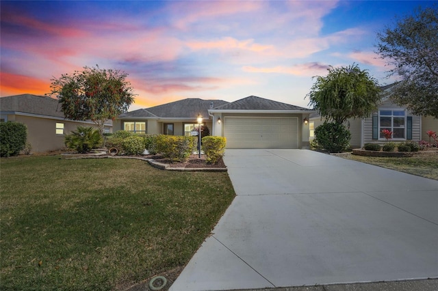 single story home with a front lawn, an attached garage, concrete driveway, and stucco siding