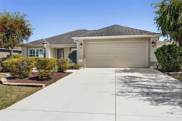 single story home with a shingled roof, an attached garage, driveway, and stucco siding