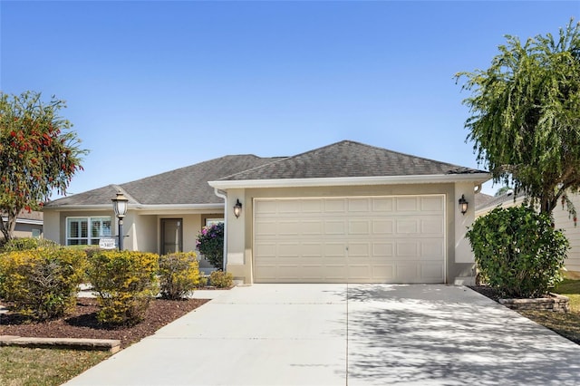 ranch-style home featuring concrete driveway, a garage, roof with shingles, and stucco siding