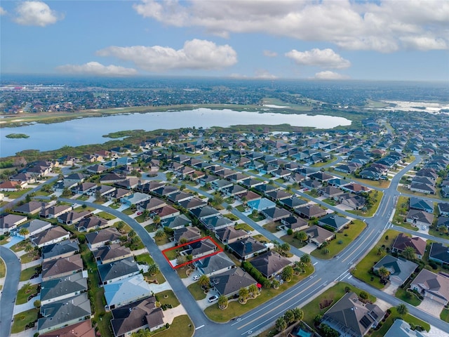 drone / aerial view with a water view and a residential view