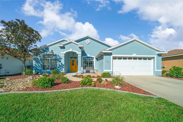 ranch-style house featuring stucco siding, a front lawn, an attached garage, and driveway