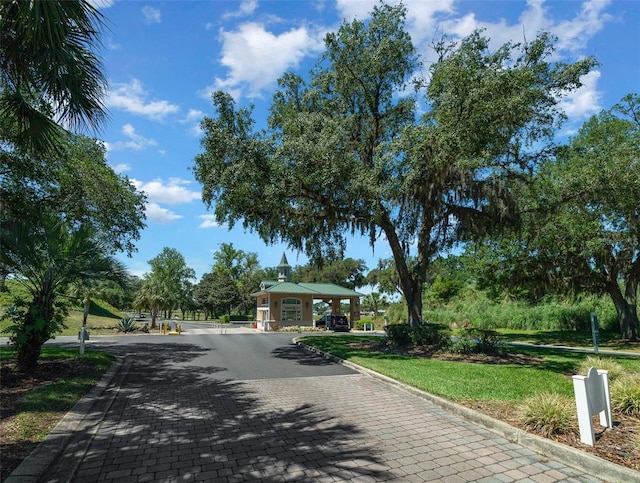 surrounding community featuring a gazebo, decorative driveway, and a yard