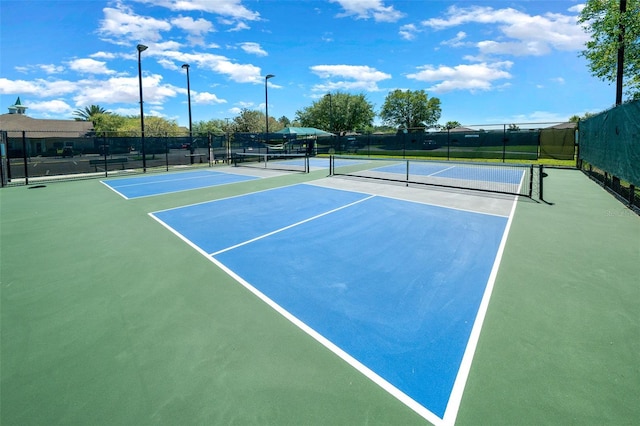 view of tennis court featuring fence