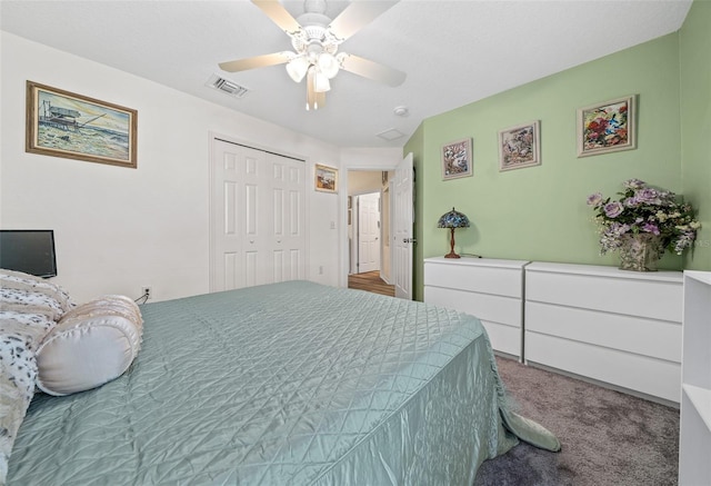 carpeted bedroom with a ceiling fan, visible vents, and a closet