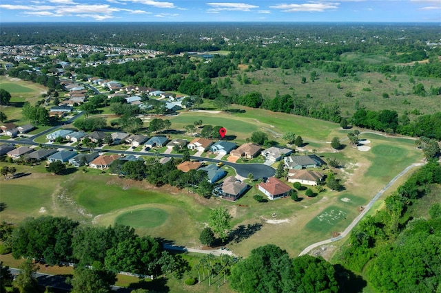 bird's eye view with a forest view, a residential view, and view of golf course