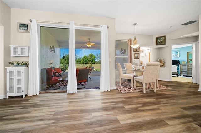 dining room with ceiling fan, visible vents, baseboards, and wood finished floors