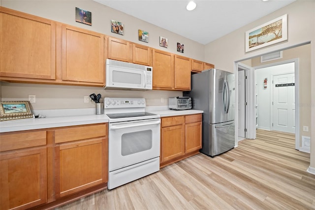 kitchen with visible vents, a toaster, light countertops, light wood-style flooring, and white appliances