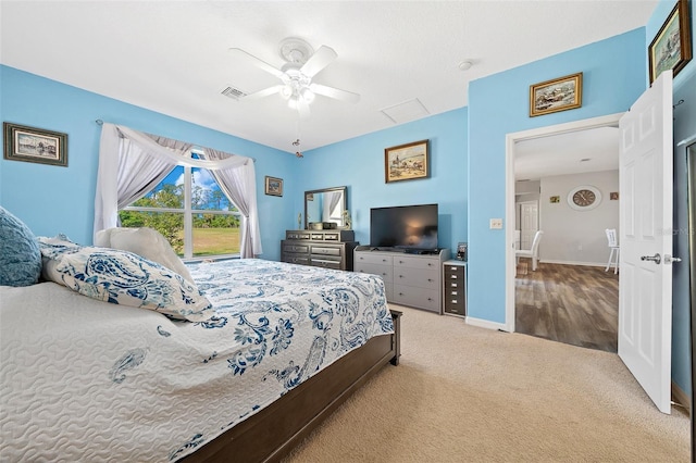 carpeted bedroom featuring visible vents, baseboards, and a ceiling fan