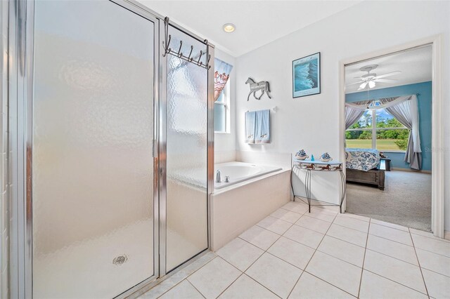 full bathroom featuring a bath, ensuite bath, a shower stall, and tile patterned flooring