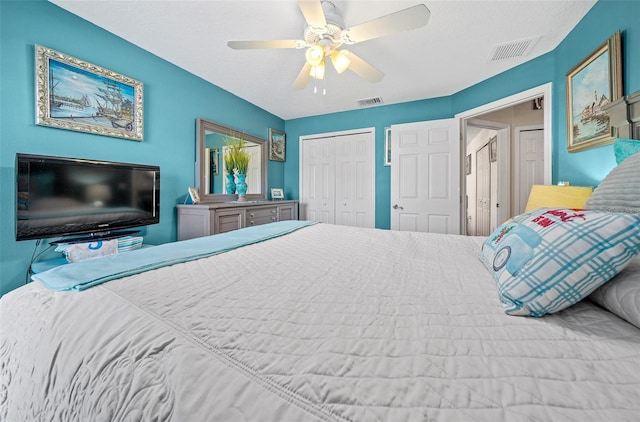 bedroom featuring a ceiling fan, visible vents, and a closet