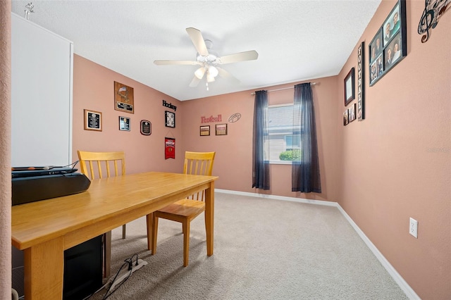 dining room featuring baseboards, carpet floors, a textured ceiling, and a ceiling fan