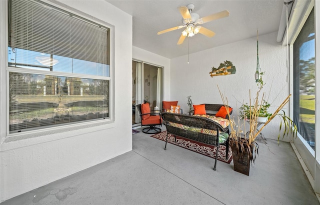 sunroom / solarium featuring ceiling fan