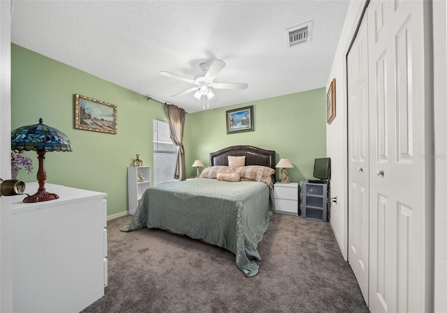 bedroom with visible vents, a textured ceiling, a closet, carpet floors, and ceiling fan