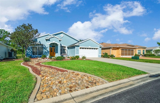 view of front facade with stucco siding, a front lawn, an attached garage, and driveway