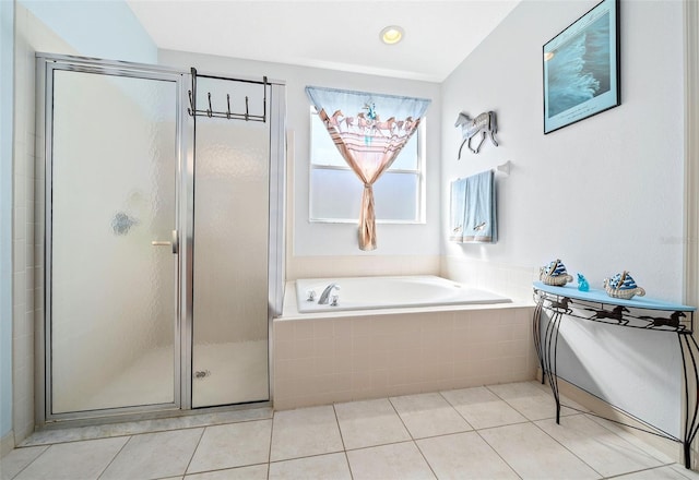 bathroom with a bath, tile patterned flooring, and a stall shower