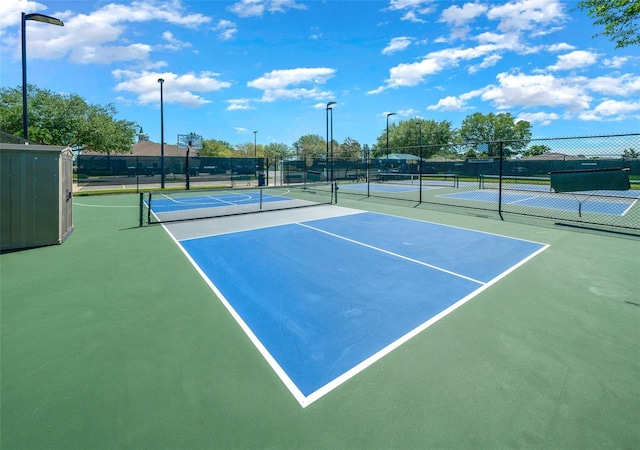 view of tennis court featuring fence