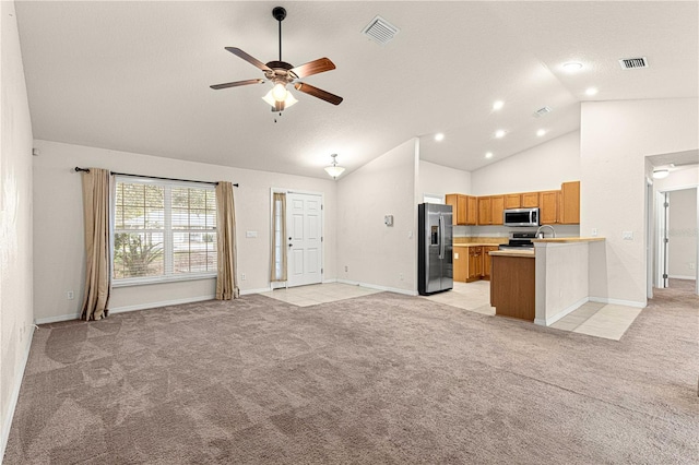 kitchen featuring light colored carpet, visible vents, open floor plan, and stainless steel appliances