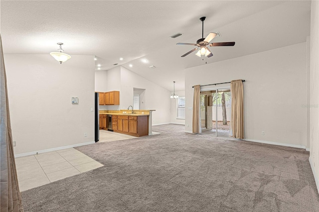 unfurnished living room with light carpet, a textured ceiling, high vaulted ceiling, a ceiling fan, and a sink