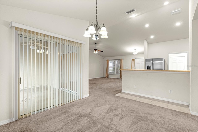 carpeted spare room featuring visible vents, ceiling fan, baseboards, and lofted ceiling