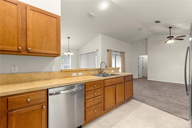 kitchen with brown cabinets, a sink, stainless steel dishwasher, light colored carpet, and vaulted ceiling