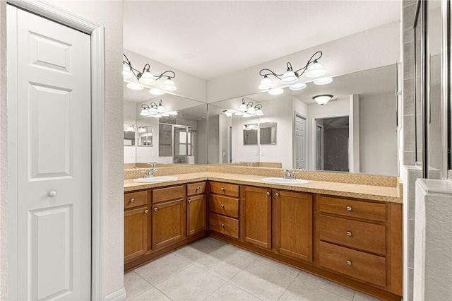 bathroom featuring tile patterned flooring, double vanity, and a sink