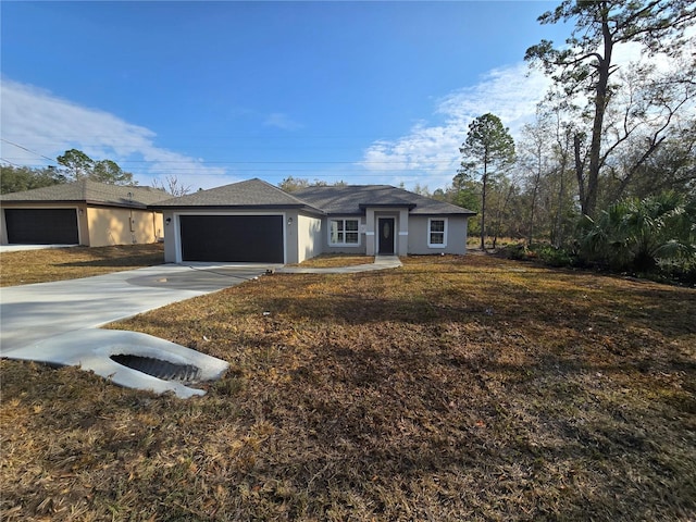 ranch-style home featuring an attached garage, driveway, and stucco siding