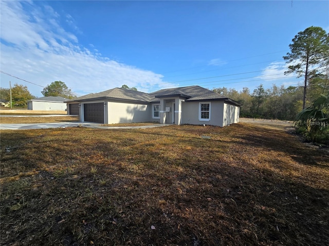 view of front of property featuring a garage, driveway, and stucco siding