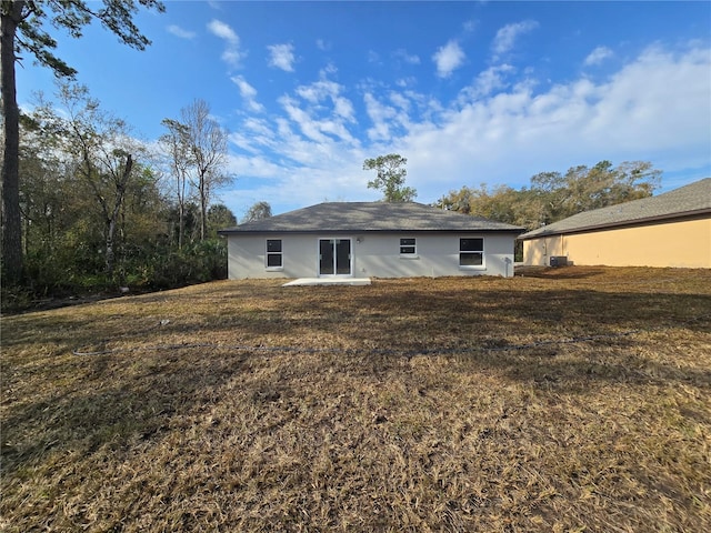 rear view of property with a lawn