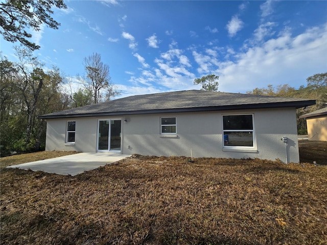 back of house featuring stucco siding and a patio area